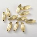 Close-up of 14k gold plated textured olive spacer beads for DIY jewelry making - 14K Gold Olive Shape (20*7mm)