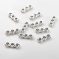 Close-up of silver-plated three-hole spacer beads for DIY jewelry making and crafts - 12.8x4.9mm / White Gold