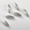 Macro detail of silver spindle shaped beads with fine vertical ridges for DIY jewelry - Silver Tone Olive Shape (20*7mm)
