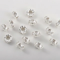Close-up of heart and flower spacer beads with cubic zirconia for DIY jewelry making - Heart Style / Silver