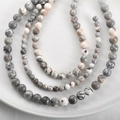 Macro shot of natural stone beads with grey marble texture and ink patterns on a ceramic tray - 14# Pink Zebra Stone / 6mm