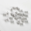 Macro shot of silver-colored wheel spacers with micro-pave cubic zirconia on white background - Small Barrel Bead (6.2*3.8mm) / 0.9mm Hole / Silver