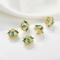 Macro detail of 14k gold plated crown pendants with green and white cubic zirconia - 25# 14k Green Zirconia Multi-loop Crown (Approx 11.8*14mm)