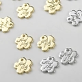 Detailed macro view of gold and silver flower metal tags engraved with Hand Made text - 8.8*9.2mm / 14k Gold Flower Tag