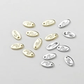Macro shot of oval gold and silver metal tags with Red engraving for DIY jewelry making - 9.1*4.7mm / 14k Gold Letter RED Tag