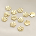 Macro shot of 14k gold plated floral tags with Hand made engraving for jewelry making - Gold Flower Style