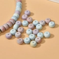 Macro shot of macaron-colored ceramic beads with natural texture for DIY jewelry making - Wheel Bead Style / Multicolor