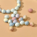 Macro shot of colorful marble textured ceramic beads for DIY jewelry making - Oval Style / Multicolor