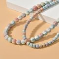Macro view of natural rainbow stone square beads on necklaces with matte textures - Small Lantern Style / Multicolor