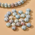 Macro shot of flower shaped natural stone beads with marble texture for DIY jewelry making - Pumpkin Style / Multicolor
