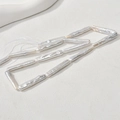 Macro detail of natural white baroque Biwa pearls showing unique long irregular shapes - Pearl White