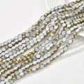 Detail shot of flat round 6mm crystal glass beads with gold plated edges for DIY jewelry - Porcelain White