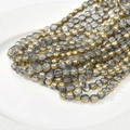 Macro shot of 6mm smoke gray glass beads and gold plated spacer beads for DIY jewelry making - Smoke Gray