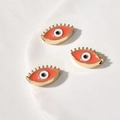 Detail von orangefarbenen Evil-Eye-Perlen mit Vergoldung für DIY-Schmuckherstellung - Augenform / 1 Stück (18.4x10.6x4.86mm) / Orange