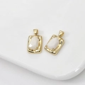 Macro detail of 14k gold plated rectangular opal charms with faceted stones for DIY jewelry - Beige Porcelain Drill Rectangular Pendant
