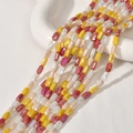 Nahaufnahme von facettierten Kristallglasperlen mit Aurora-Beschichtung für DIY-Schmuck - 1 Strang 76 Stück / 14# Rot-Gelb-Serie