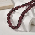 Macro shot of irregular deep purple glass beads for jewelry making on a white stone background - Purple Irregular Shape