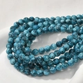 Macro view of 8mm colorful oil painting style round turquoise beads in a ceramic tray - Blue Turquoise Splatter (17#) / 8mm Diameter