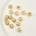 Macro shot of gold cylinder beads with letter L and 7 zircon inlay for jewelry making - Number 7 / 1 Piece (Approx. 6.5x5.2mm)
