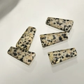 Detailed view of flat trapezoid Dalmatian stone pendants with natural spotted textures - Dalmatian Jasper