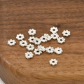 Close-up of silver flower spacer beads on wooden base for DIY jewelry making - 16# Style (5mm / 50 Pcs/Pack) / Silver