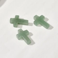 Detailed view of three polished light green natural aventurine stone cross pendants - #14 Green Tonkin Cross [1 Piece] Approx. 26.4*17.8mm (color Shade Random)