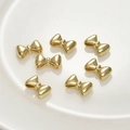 Polished 14k gold plated bow-shaped spacer beads for DIY jewelry making and bracelet assembly - 14K Gold Bow / Double Hole Spacer Bead
