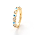 Close-up of gold evil eye ring with blue enamel eyes and micro-set cubic zirconia stones - Evil Eye Style / White