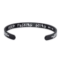 Macro view of matte black stainless steel C-shape cuff with engraved motivational text - C Shape / Black