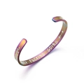 Macro detail of rainbow stainless steel cuff with Keep Fucking Going engraving - C-Shape (B830) / Rainbow