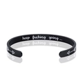 Macro detail of engraved inner band on black matte stainless steel C-shaped cuff bracelet - C-Shape (B820) / Black