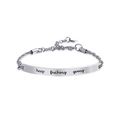 Detailed close-up of polished titanium steel bracelet plate with motivational engraving - Silver