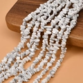 Close-up of natural white howlite stone chips for DIY jewelry making on wooden display - 1 String (Approx. 235 Beads) / Howlite