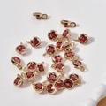 Macro detail of 14k gold plated clover pendants with red rhinestones for DIY jewelry making - 12# Rose Red Round Style