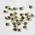 Macro view of green four-leaf clover charms with gold plating and clear rhinestone details - 17# Green Round Style