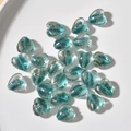 Macro shot of heart-shaped glass beads with gold foil inside for DIY jewelry making - 1 Piece / Lake Blue Gold Sand