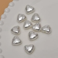 Close-up of heart-shaped faux pearl beads with metallic luster for DIY jewelry making - Mabe Iridescent / 15mm