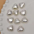 Close-up of heart-shaped silver metallic beads on a white tray for jewelry DIY - Bright White / 18mm