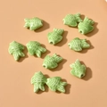 Detailed view of light green ceramic fish beads with textured scales and hole for DIY jewelry - Small Fish Style (13#) / 1 Piece / Light Green