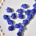 Close-up of dark blue ceramic fish beads with glossy finish and scales on white plate - Small Fish Style (15#) / 1 Piece / Dark Blue