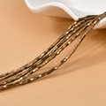 Dettaglio macro di perline a cubo in ematite oro scuro da 2mm per la creazione di gioielli - Oro Bronzo