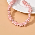 Close-up of pink glazed ceramic star beads for DIY handmade jewelry crafting - Deep Pink