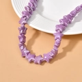 Detailed view of glossy purple star-shaped ceramic beads for DIY handmade jewelry crafts - Purple