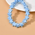 Close-up of sky blue glazed ceramic star beads for DIY jewelry and bracelets - Peacock Blue