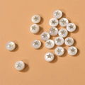 Close-up of circular freshwater shell beads with gold star inlay for DIY jewelry making - Star (5#) / 1 Piece / White