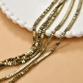 Macro shot of 2x4mm gold plated hematite faceted rectangular beads for DIY jewelry - Light gold
