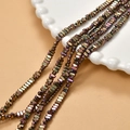 Macro detail of 2x4mm rectangular hematite beads with iridescent metallic plated finish - Light Purple Gold