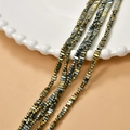 Detailed view of 2x4mm gold-plated hematite square spacer beads for DIY jewelry making - Blue Gold