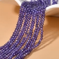 Detailed macro view of 2mm faceted deep purple zircon loose beads for DIY jewelry making - Purple Zircon