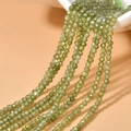 Close-up of 2mm olive green faceted zircon beads for DIY jewelry making and necklaces - Light Green Zirconia
